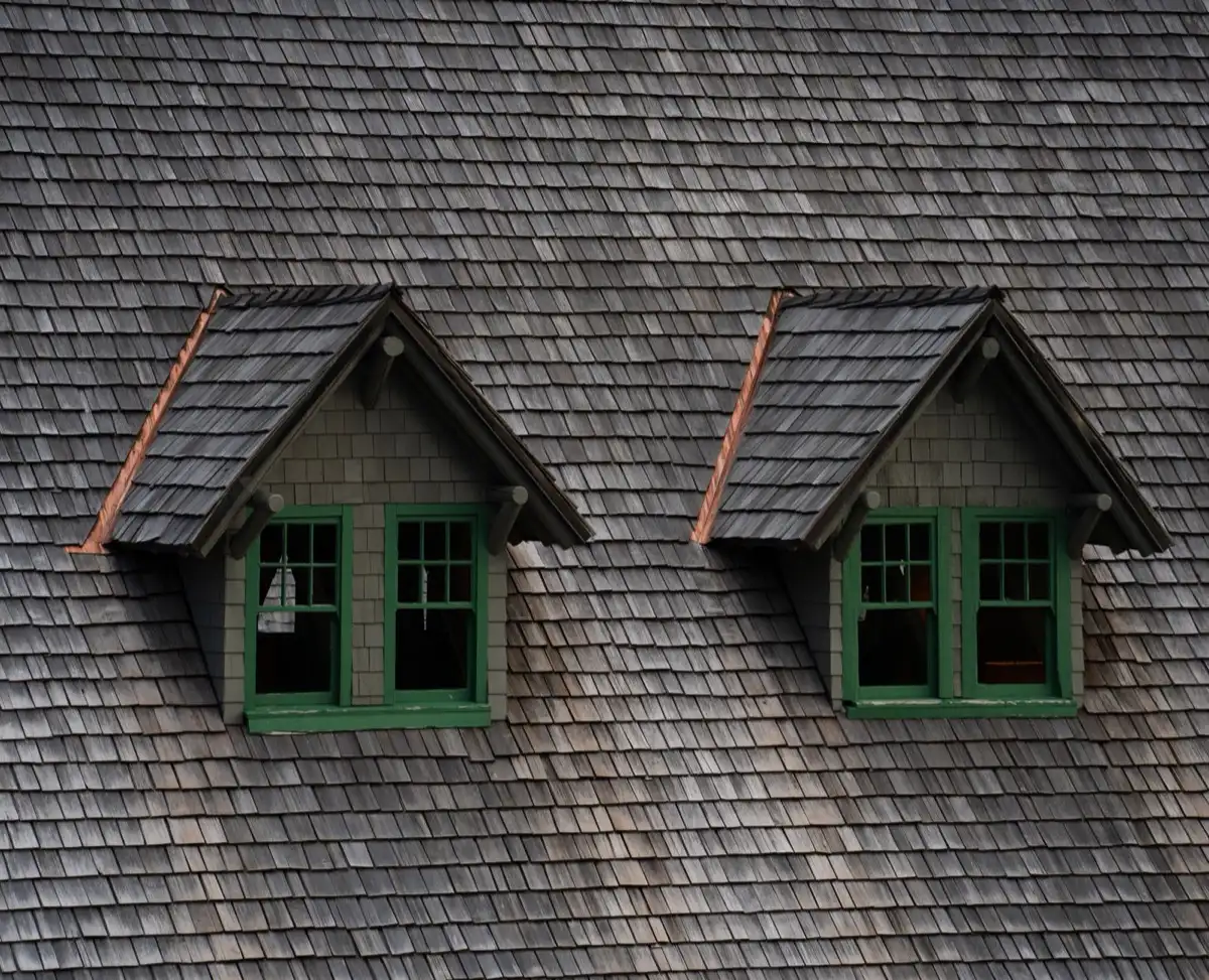 Dormers on a shingle roof in Rogers, AR, where step flashing and kickout flashing carry water past the walls