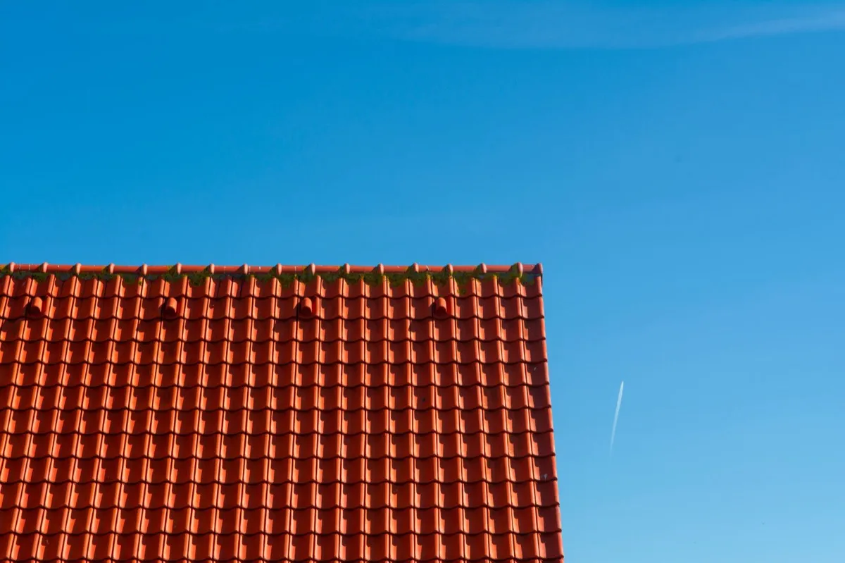 Tile roof gable in full sun, the kind of exposure that sets roof life in Rogers, AR
